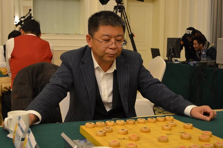 Li Laiqun in a pinstripe suit at the board